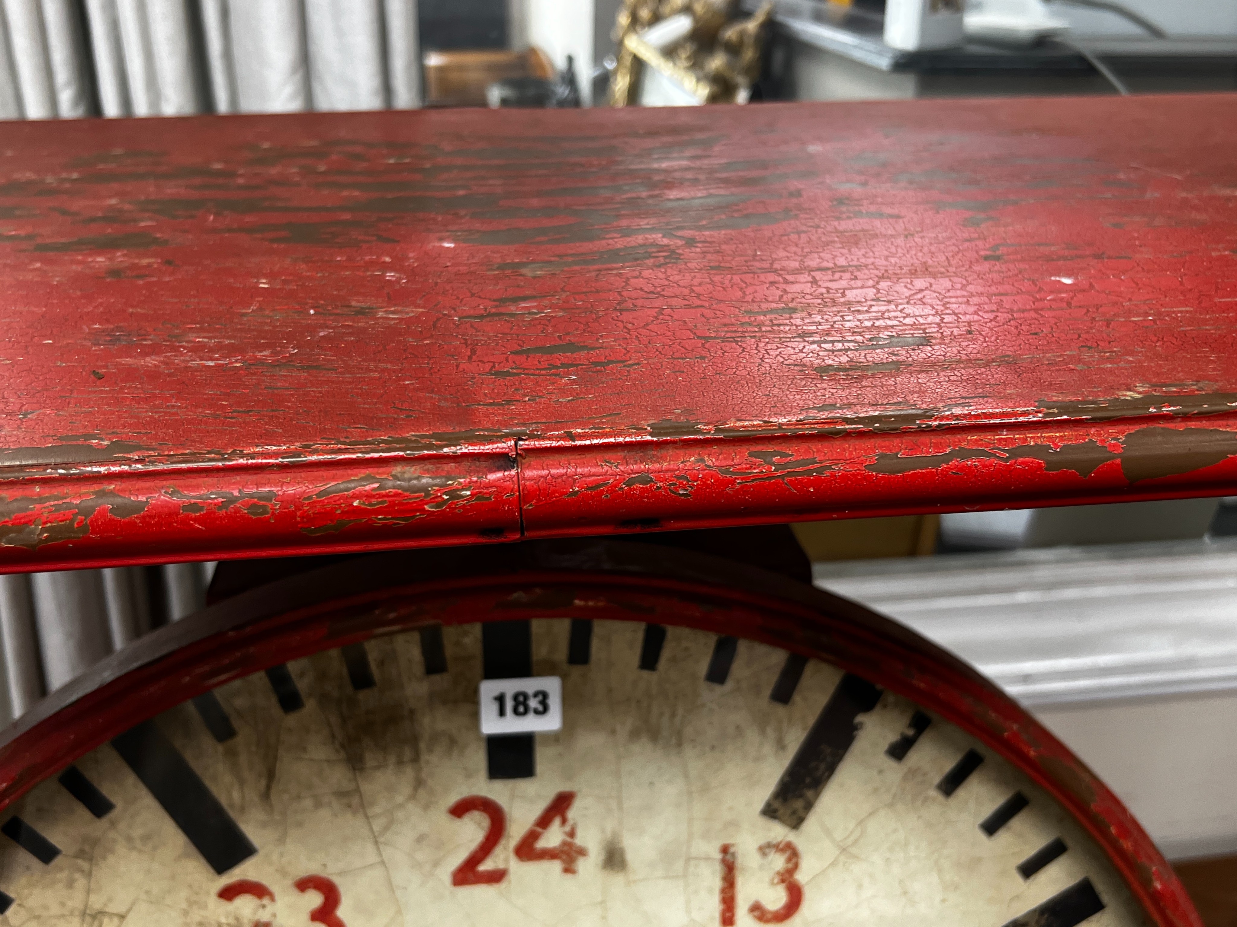 An industrial style painted metal clock console table modelled as a set of scales, width 102cm, depth 46cm, height 80cm.